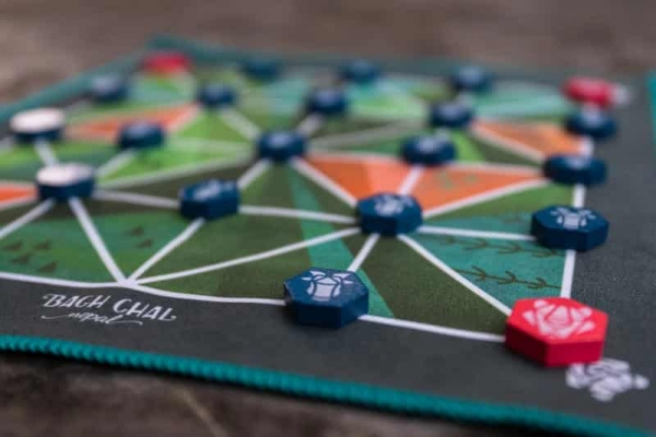 The silken game board cloth and the small wooden game tokens (photo courtesy of Lemery Games)