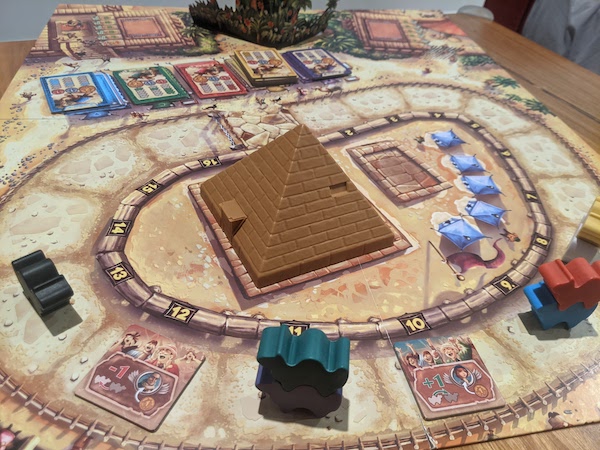 Middle of a game of Camel Up, Green camel is currently winning. The pyramid in the middle holds all a die for each camel.