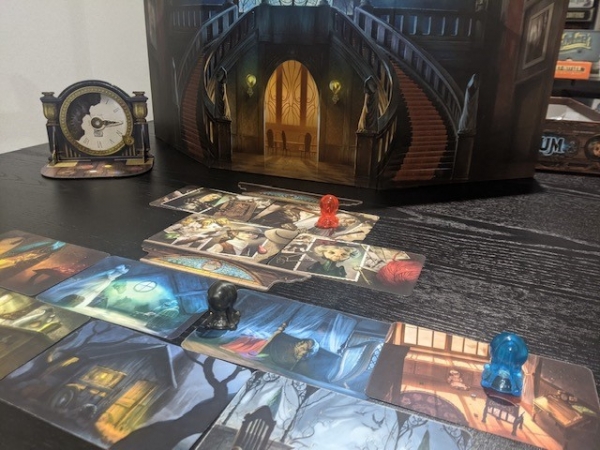 The middle of a game of Mysterium. The red player is still guessing the suspect, while black and blue are onto Locations.